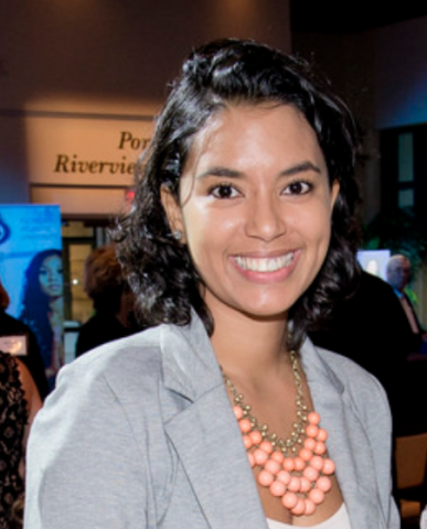 headshot of Isabelle Clerie. She has brown, medium length hair. She is wearing a grey shirt and a necklace. She is smiling. 